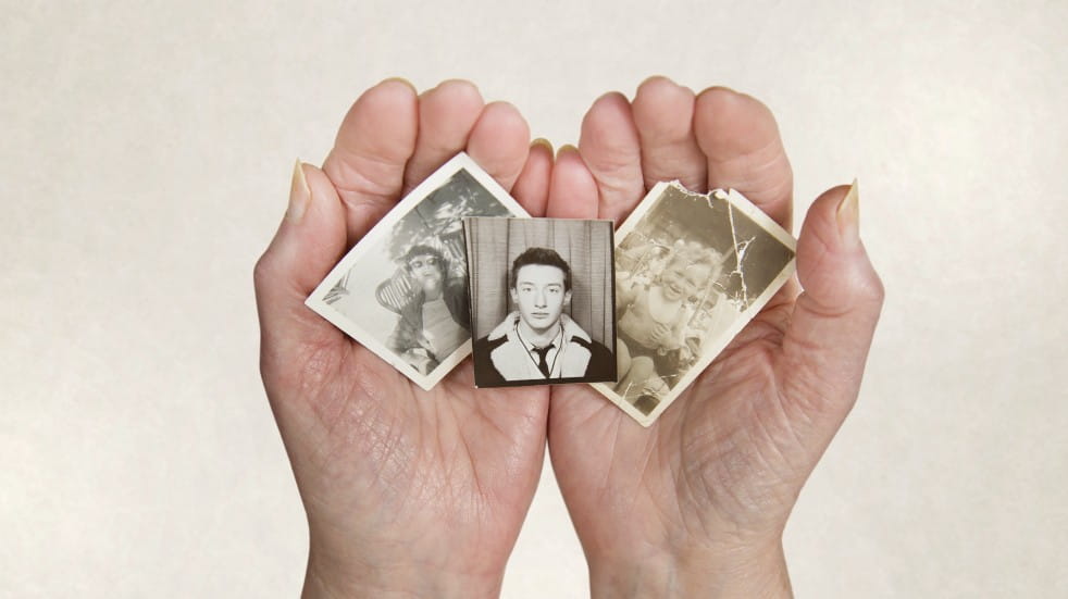 hands holding old photographs